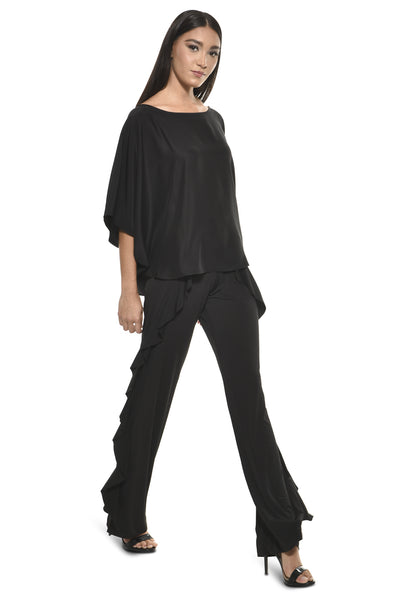 Model wearing Julian Chang Ivani Top in Black paired with Fiat Pant in Black, featuring a boat neckline and ruffled side details